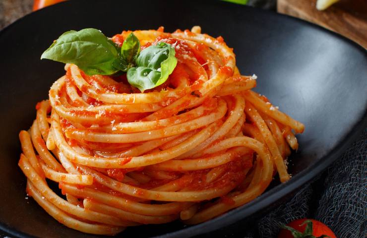 Pasta con sugo nel piatto nero